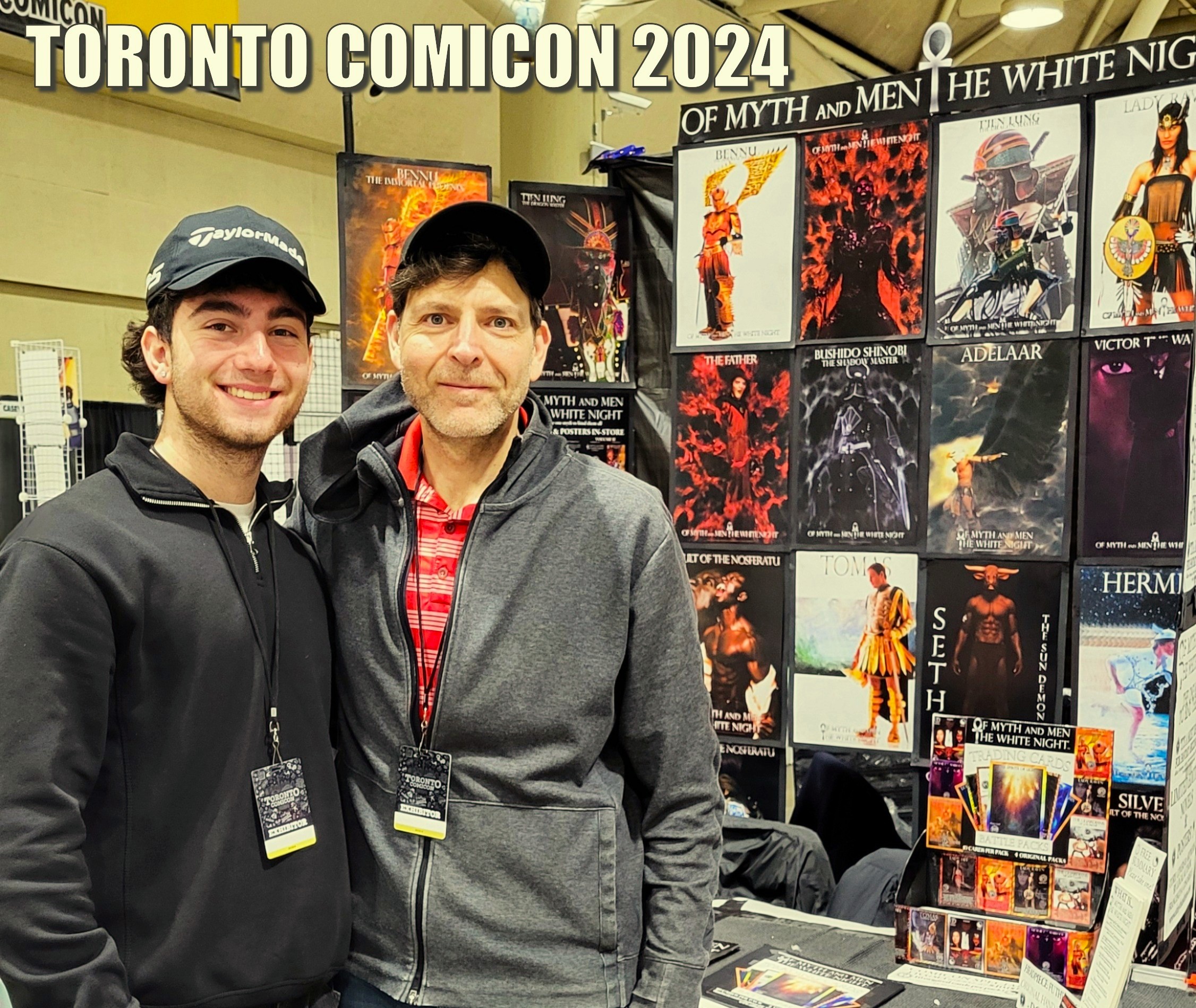 Author Francesco Coscarella and nephew standing in front of his exhibit at Toronto Comicon from Of Myth and Men: The White Night by Francesco Coscarella